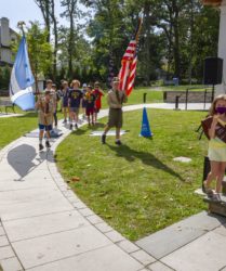 Boy Scouts marching with flags