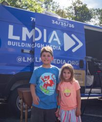 Kids attending Larchmont Day posing in front of LMC Van